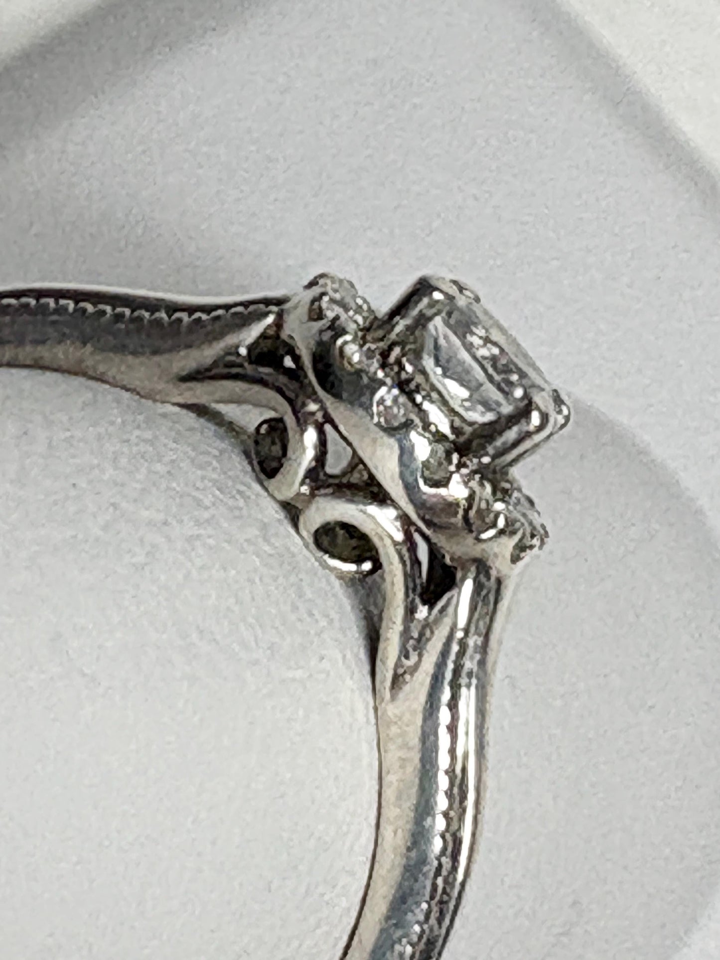 Sterling silver ring with a white sapphire and diamond halo.