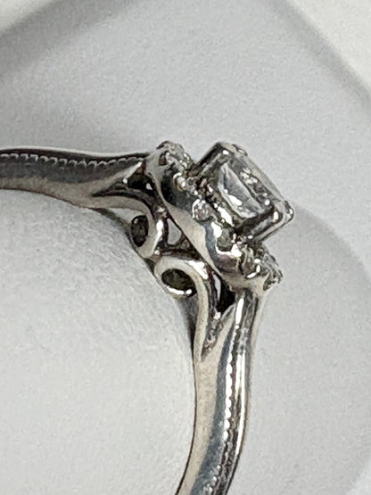 Sterling silver ring with a white sapphire and diamond halo.