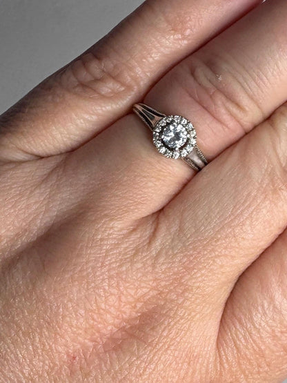 Sterling silver ring with white sapphire and diamond halo.