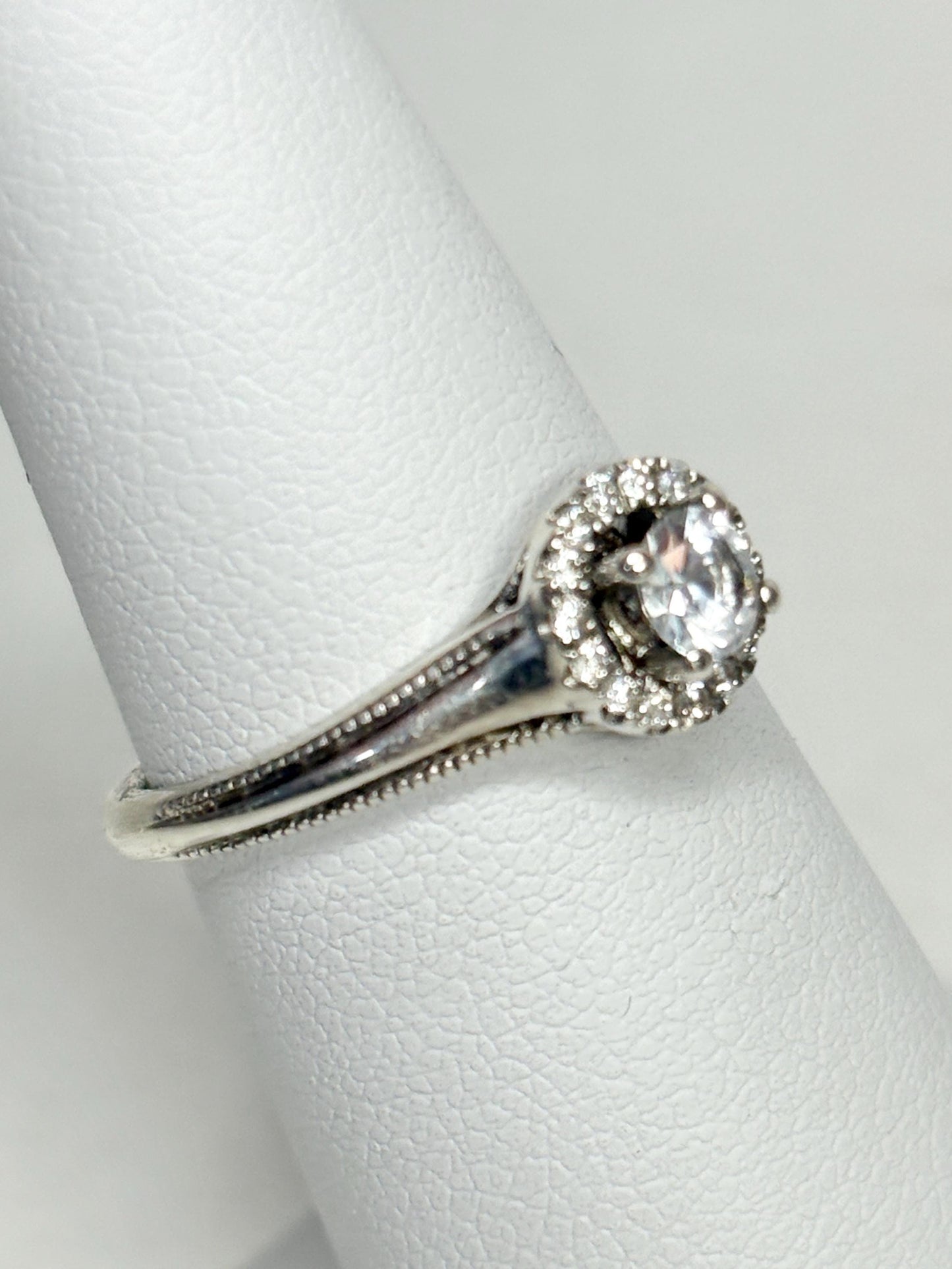 Sterling silver ring with a white sapphire and diamond halo.