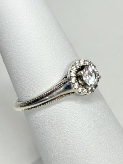 Sterling silver ring with a white sapphire and diamond halo.