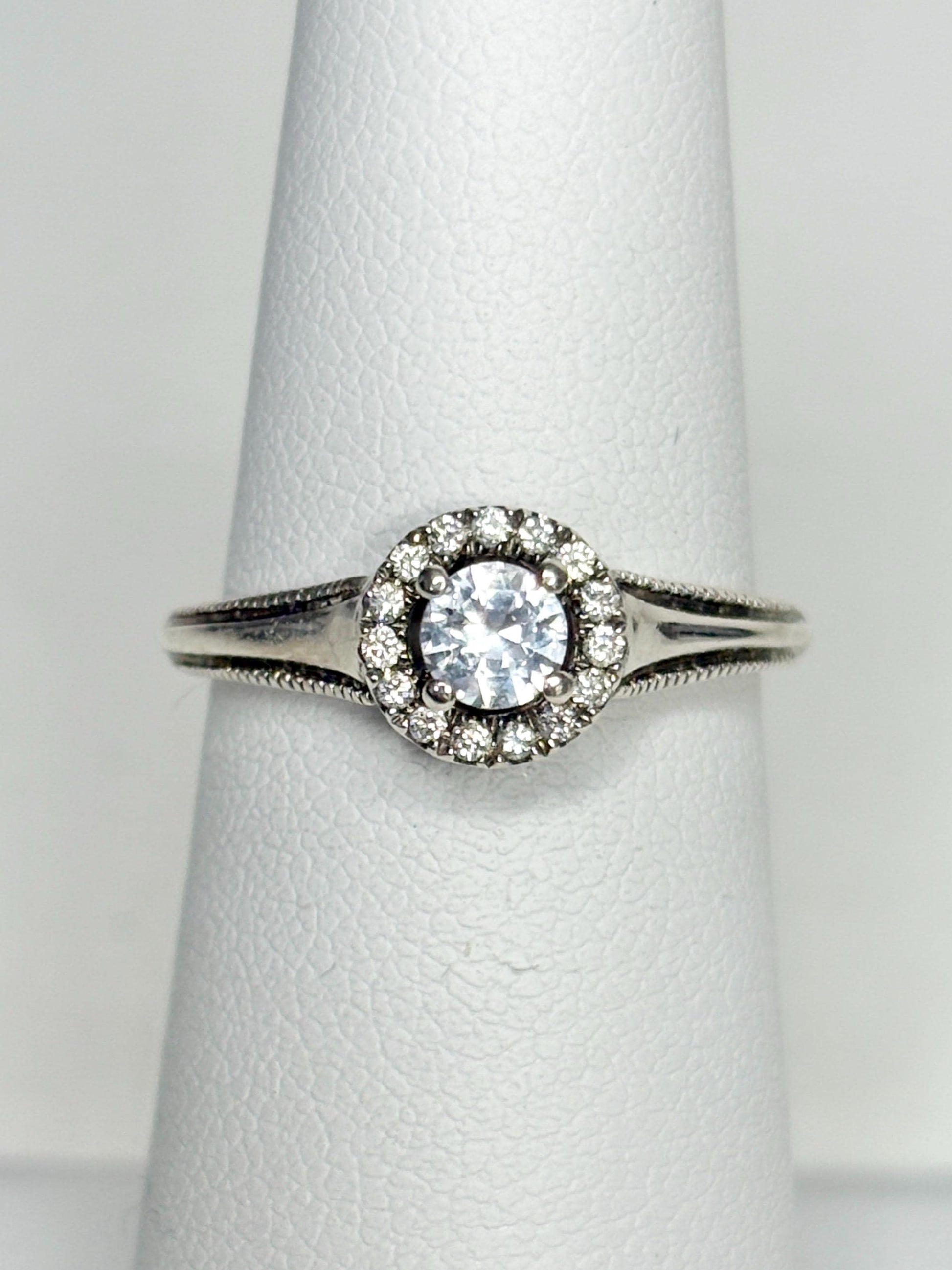 Sterling silver ring with white sapphire and diamond halo.