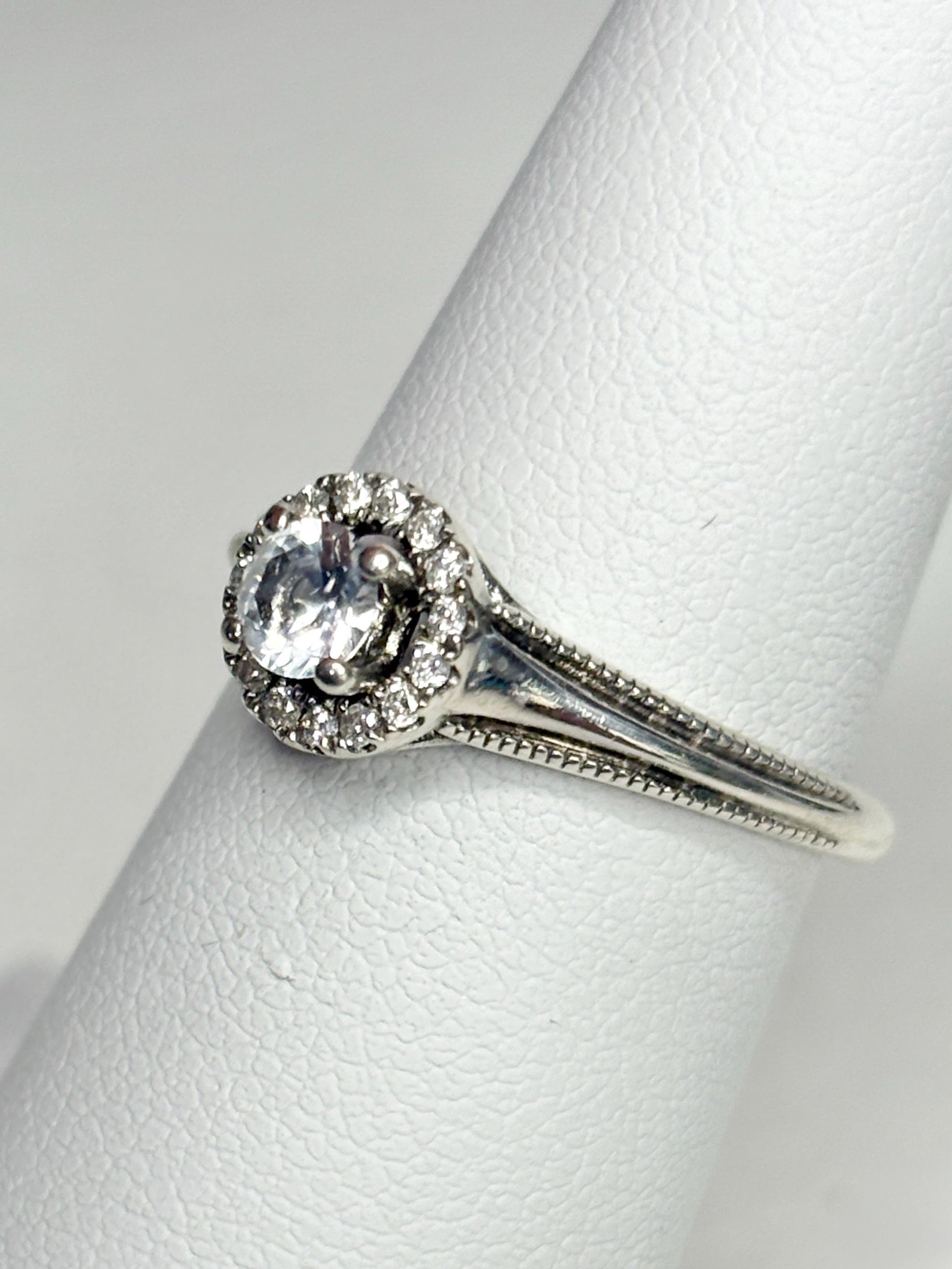 Sterling silver ring with a white sapphire and diamond halo.