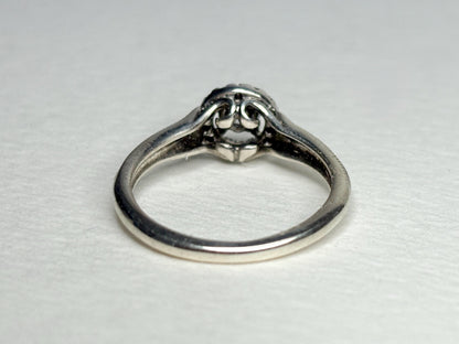 Sterling silver ring with a white sapphire and diamond halo.