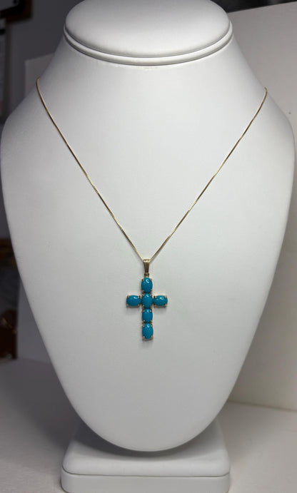 14k gold necklace with a cross pendant featuring six oval Sleeping Beauty turquoise stones.