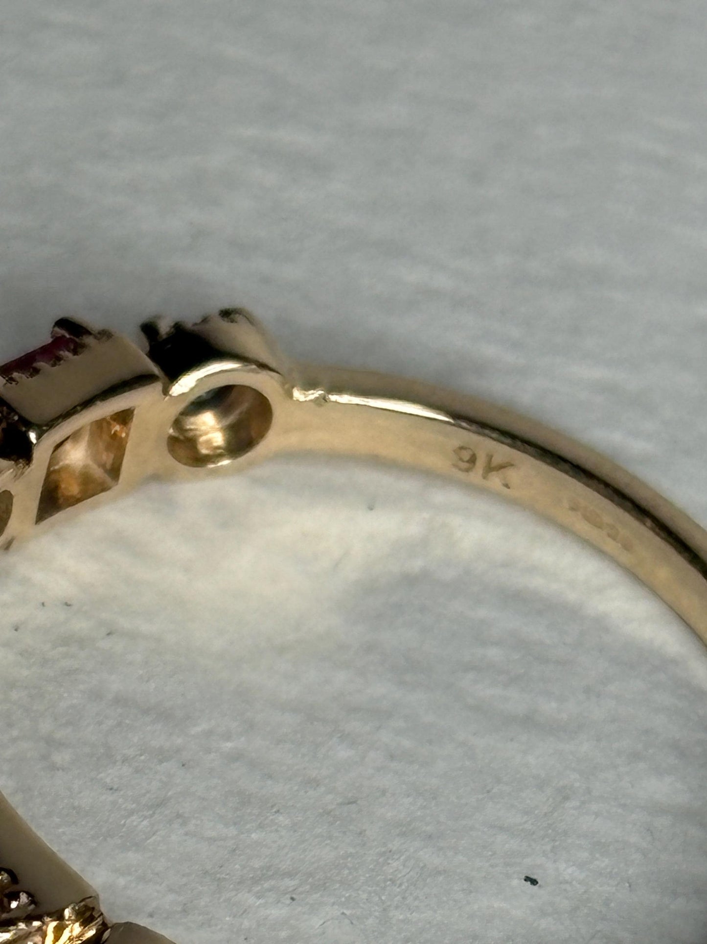 A 9k gold ring with pink and violetish-blue sapphires.