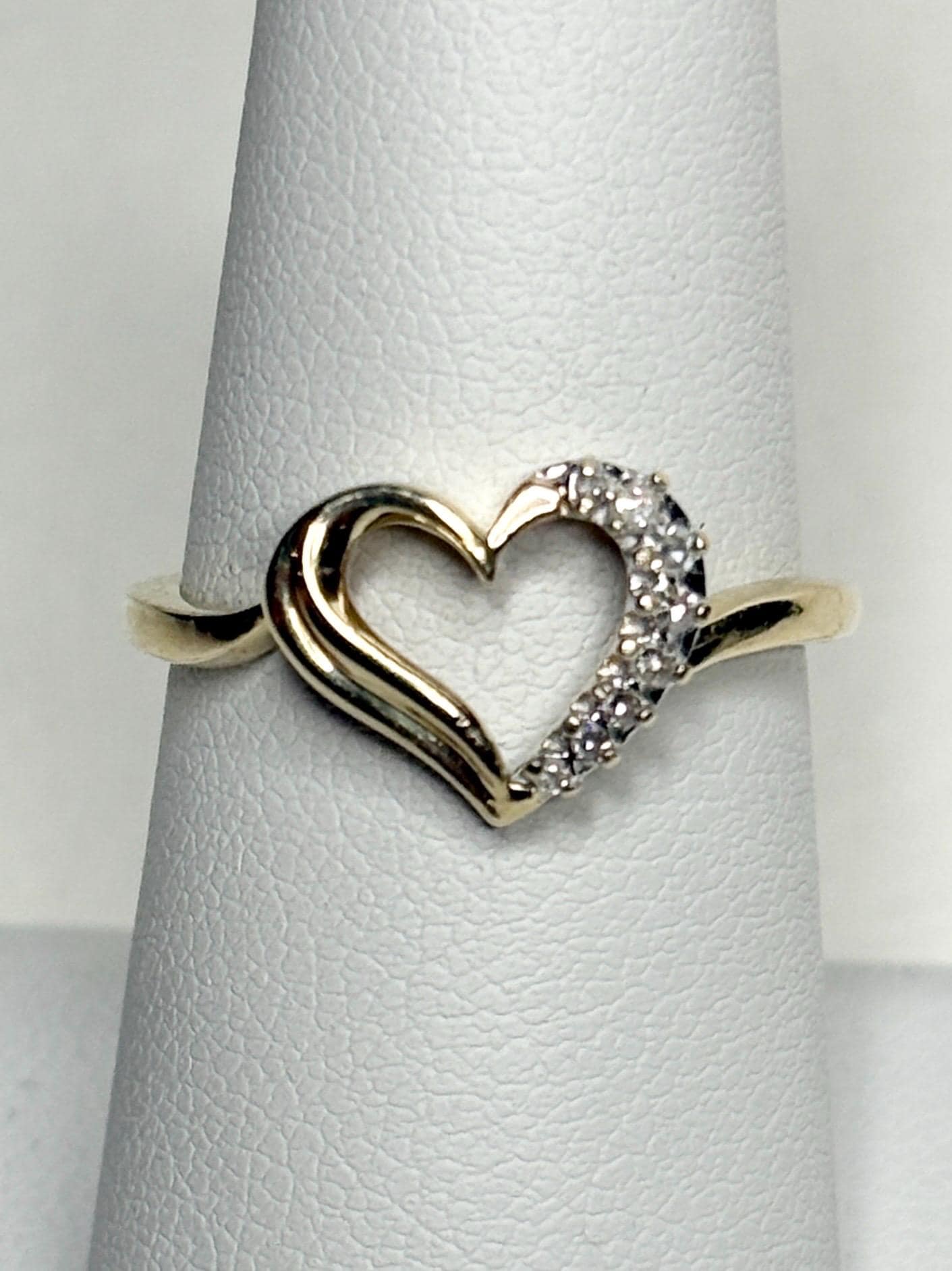 A 10k yellow gold heart ring with diamonds.