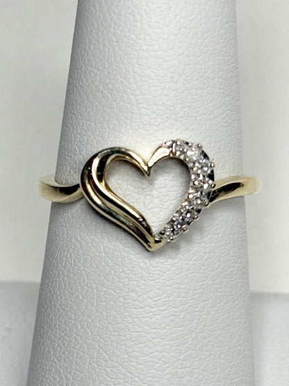 A 10k yellow gold heart ring with diamonds.