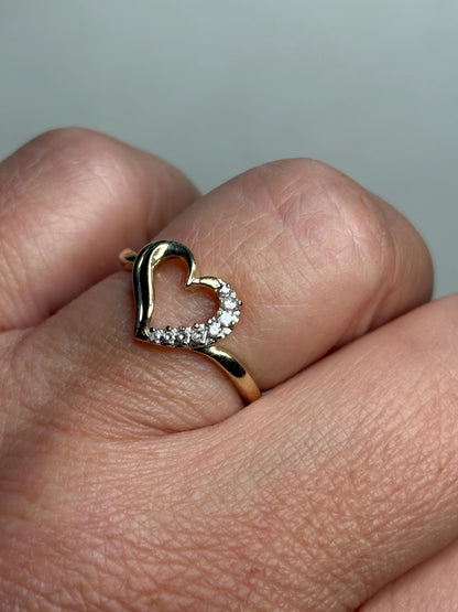 A 10k yellow gold heart ring with eight small diamonds.