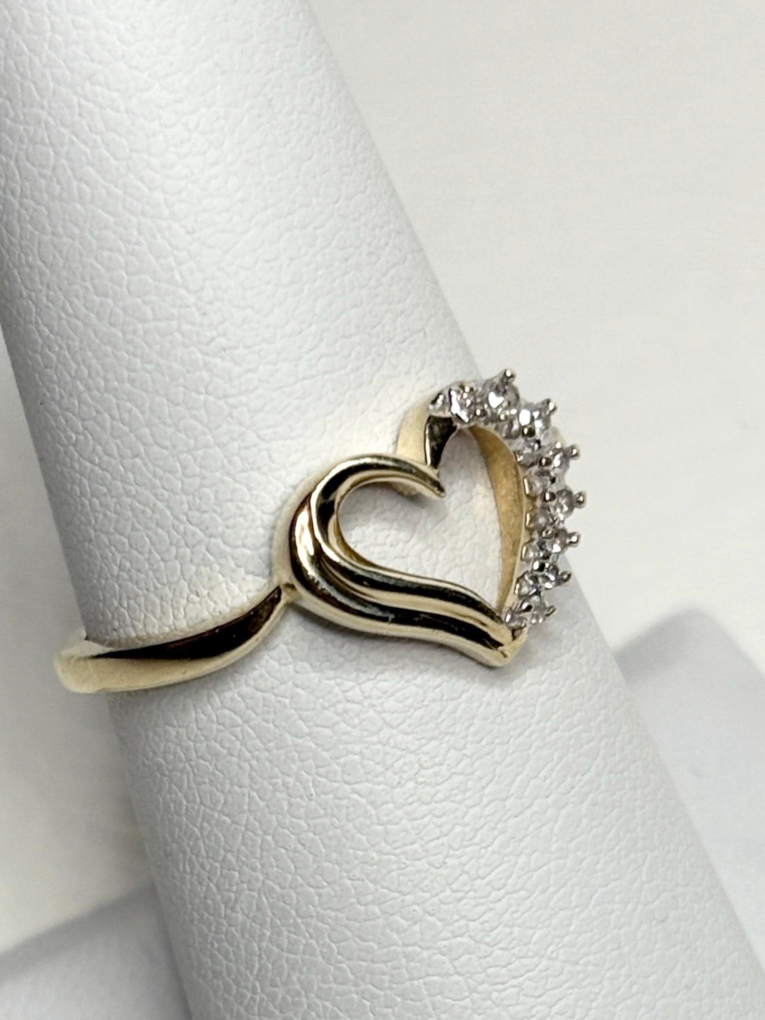 A 10k yellow gold heart ring with diamonds.