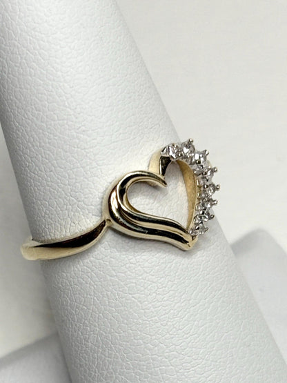 A 10k yellow gold heart ring with diamonds.