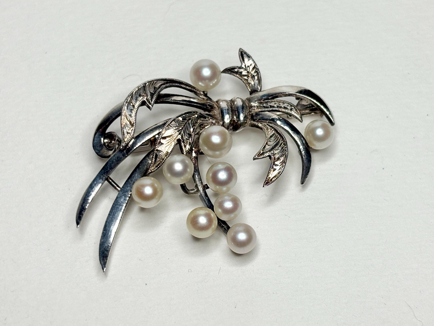 Vintage sterling silver bow brooch with 9 Akoya cultured pearls.
