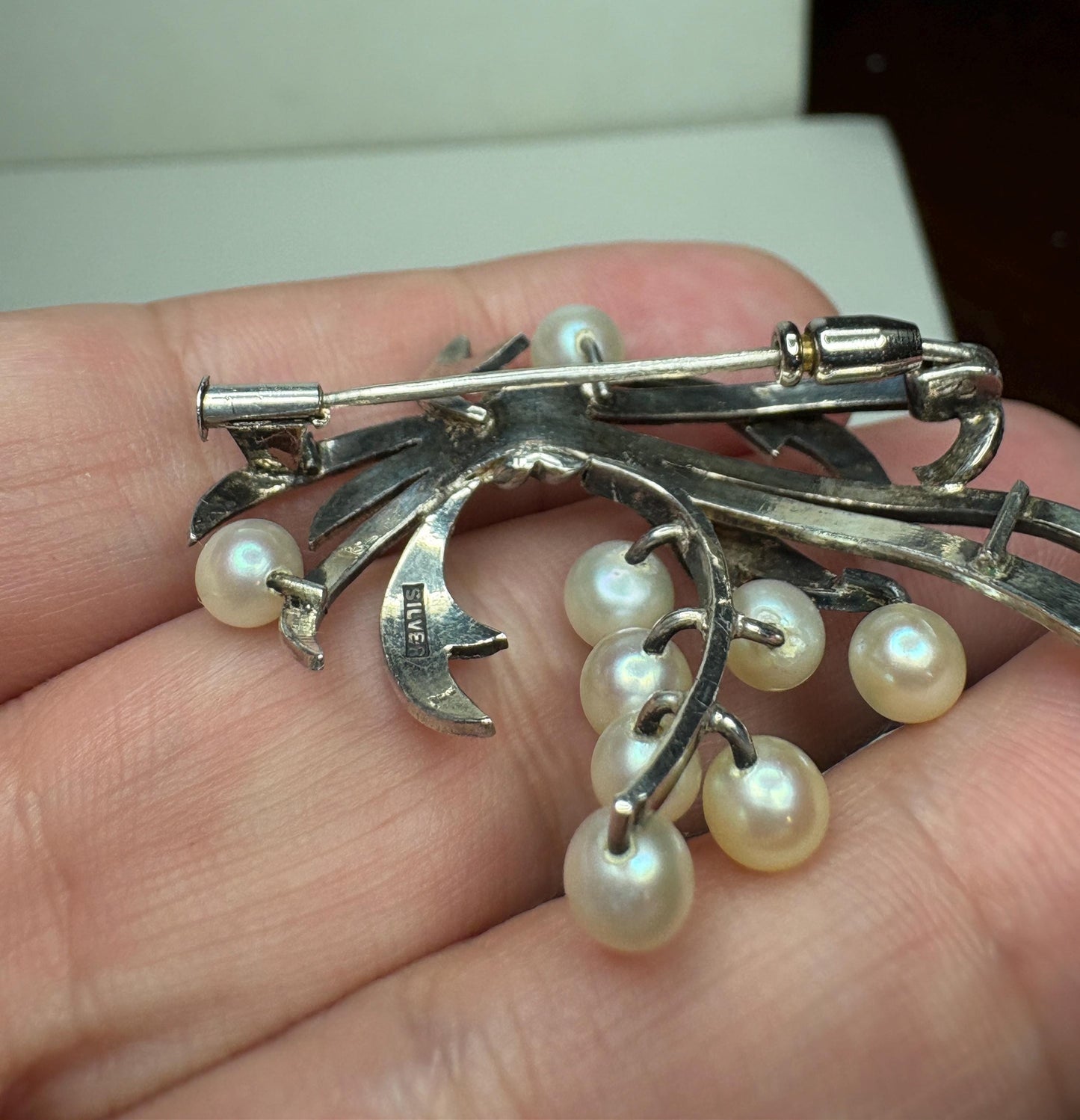 Vintage sterling silver brooch with nine Akoya cultured pearls.