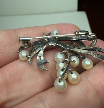 Vintage sterling silver brooch with nine Akoya cultured pearls.