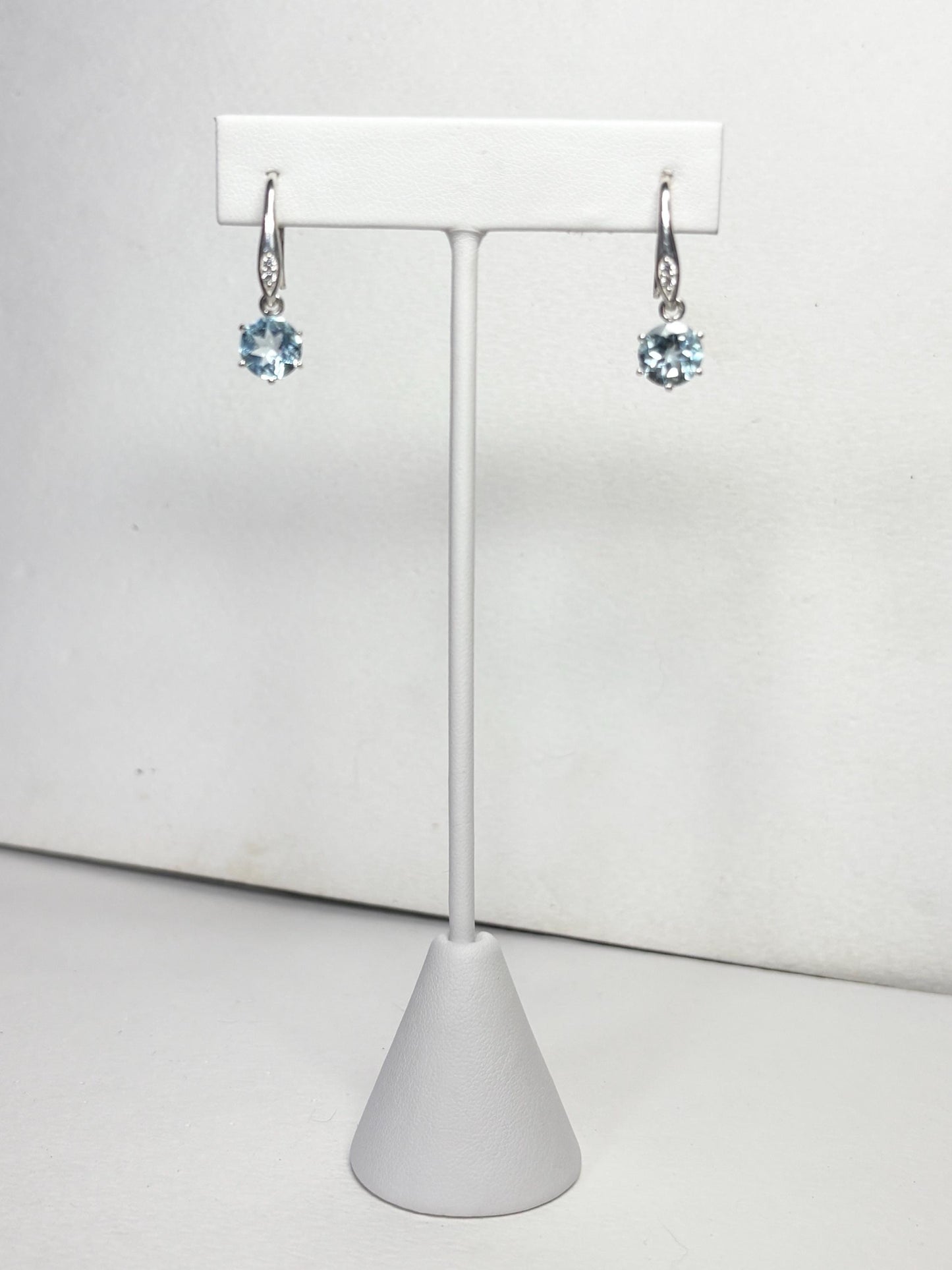 Sterling silver dangle earrings with blue topaz and zircon.