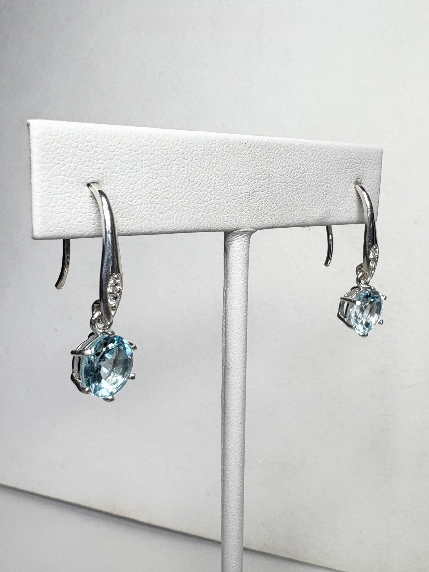 Sterling silver dangle earrings with blue topaz and white zircon.