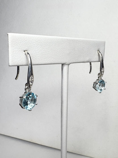 Sterling silver dangle earrings with blue topaz and white zircon.