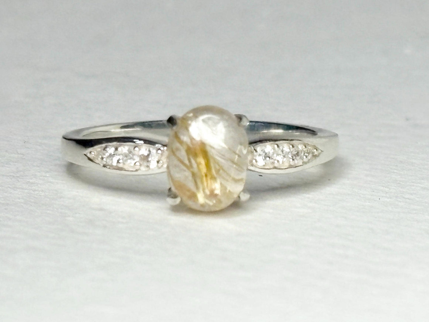 Sterling silver ring with rutilated quartz and zircon accents.