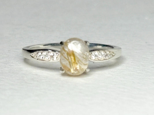 Sterling silver ring with rutilated quartz and zircon accents.