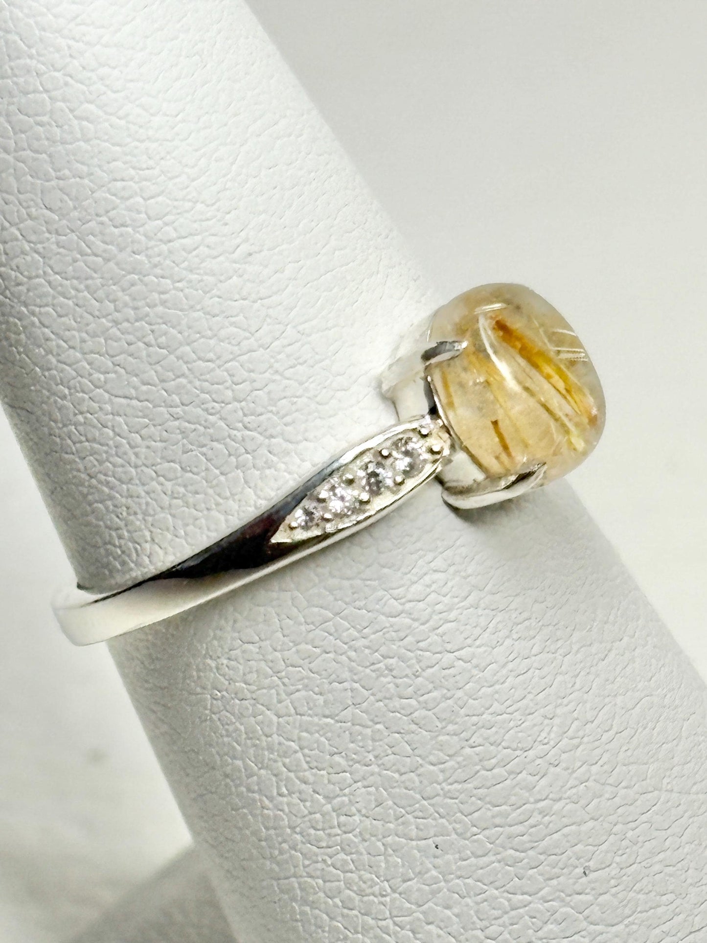 Sterling silver ring with rutilated quartz and zircon accents.