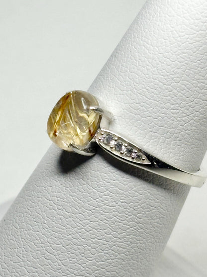 Sterling silver ring with rutilated quartz and zircon accents.