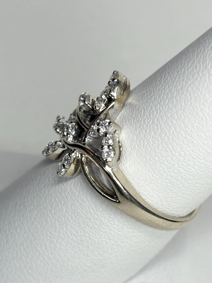A 14k white gold ring with a vine design and 1/2 carat of diamonds.