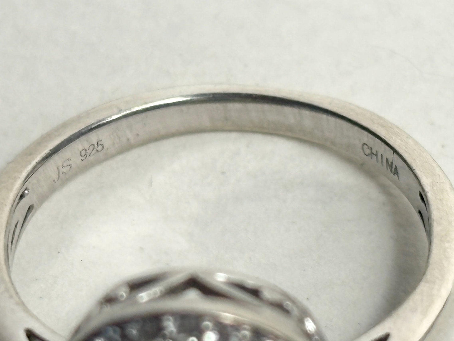 Sterling silver ring with "JS 925" and "CHINA" engravings.