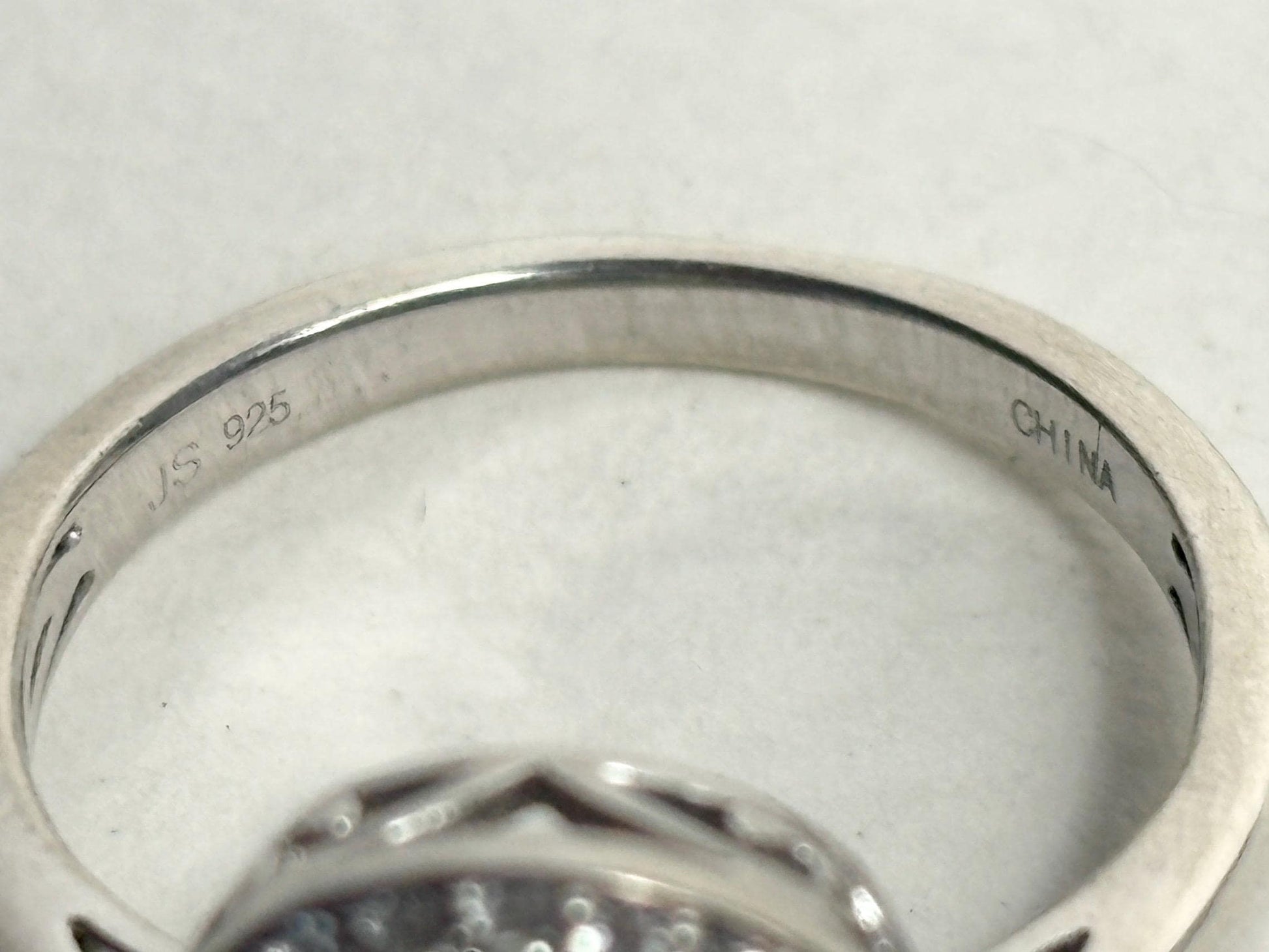 Sterling silver ring with "JS 925" and "CHINA" engravings.