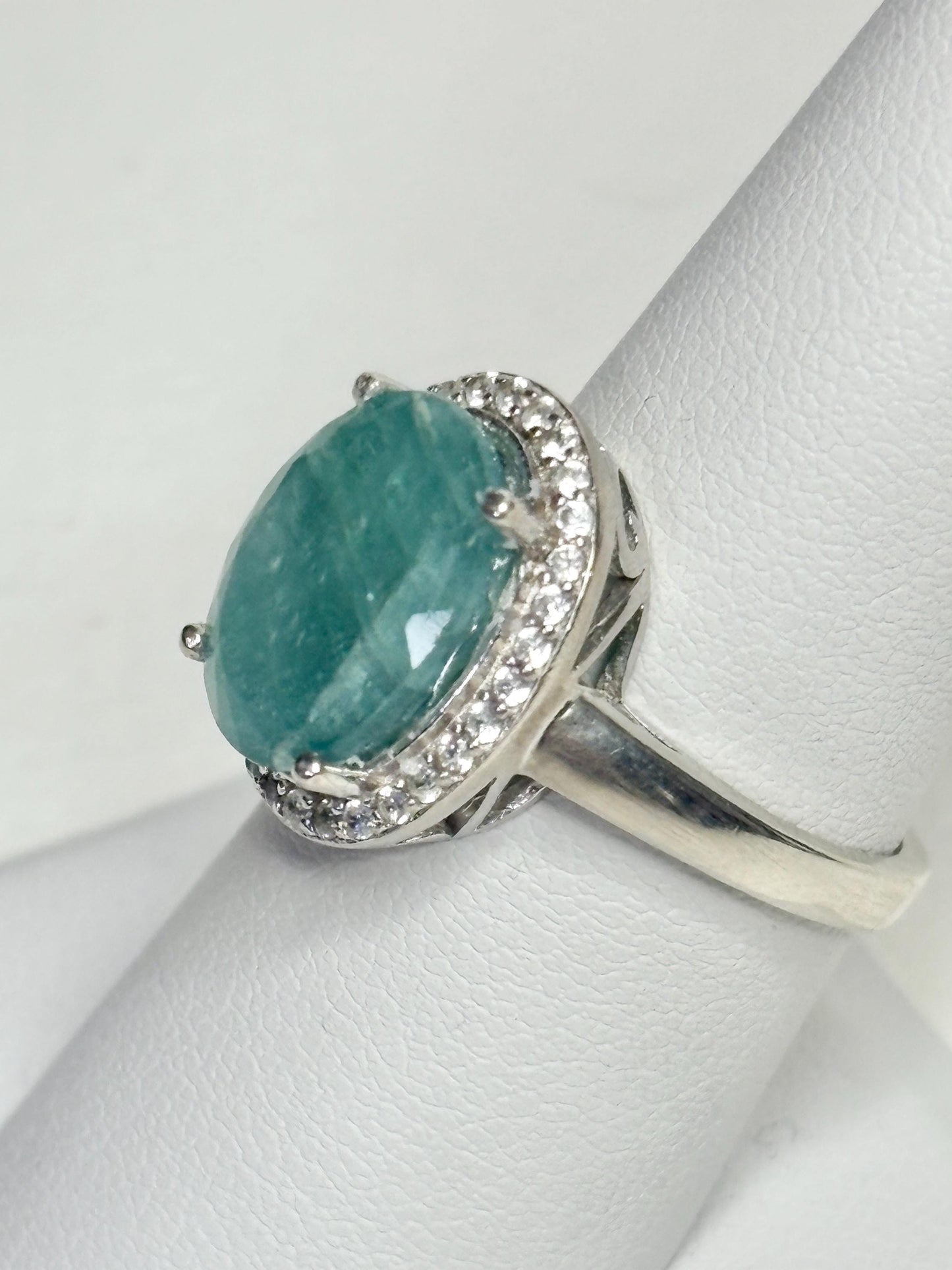 Sterling silver ring with a large oval grandidierite and zircon halo.