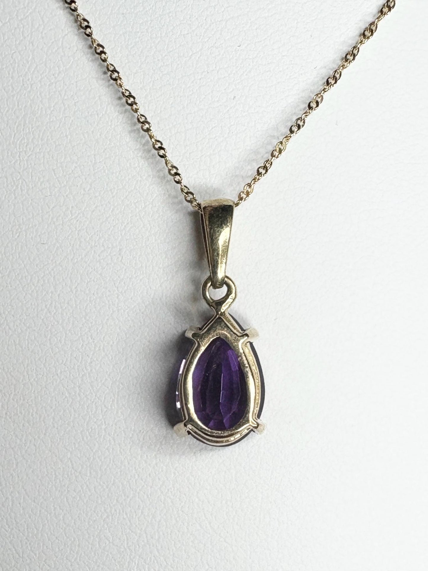 14k gold necklace with a pear-shaped amethyst pendant.