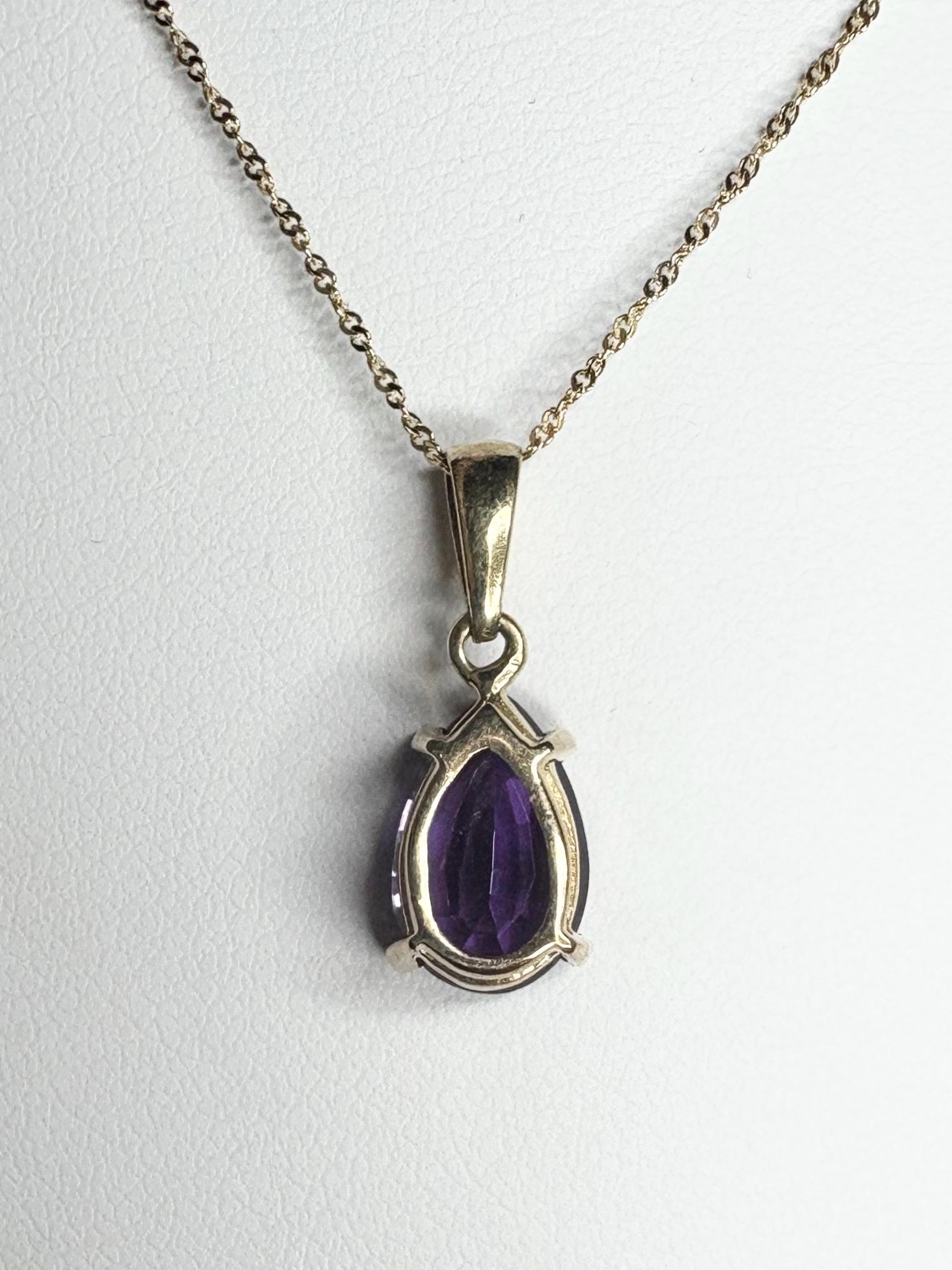 14k gold necklace with a pear-shaped amethyst pendant.