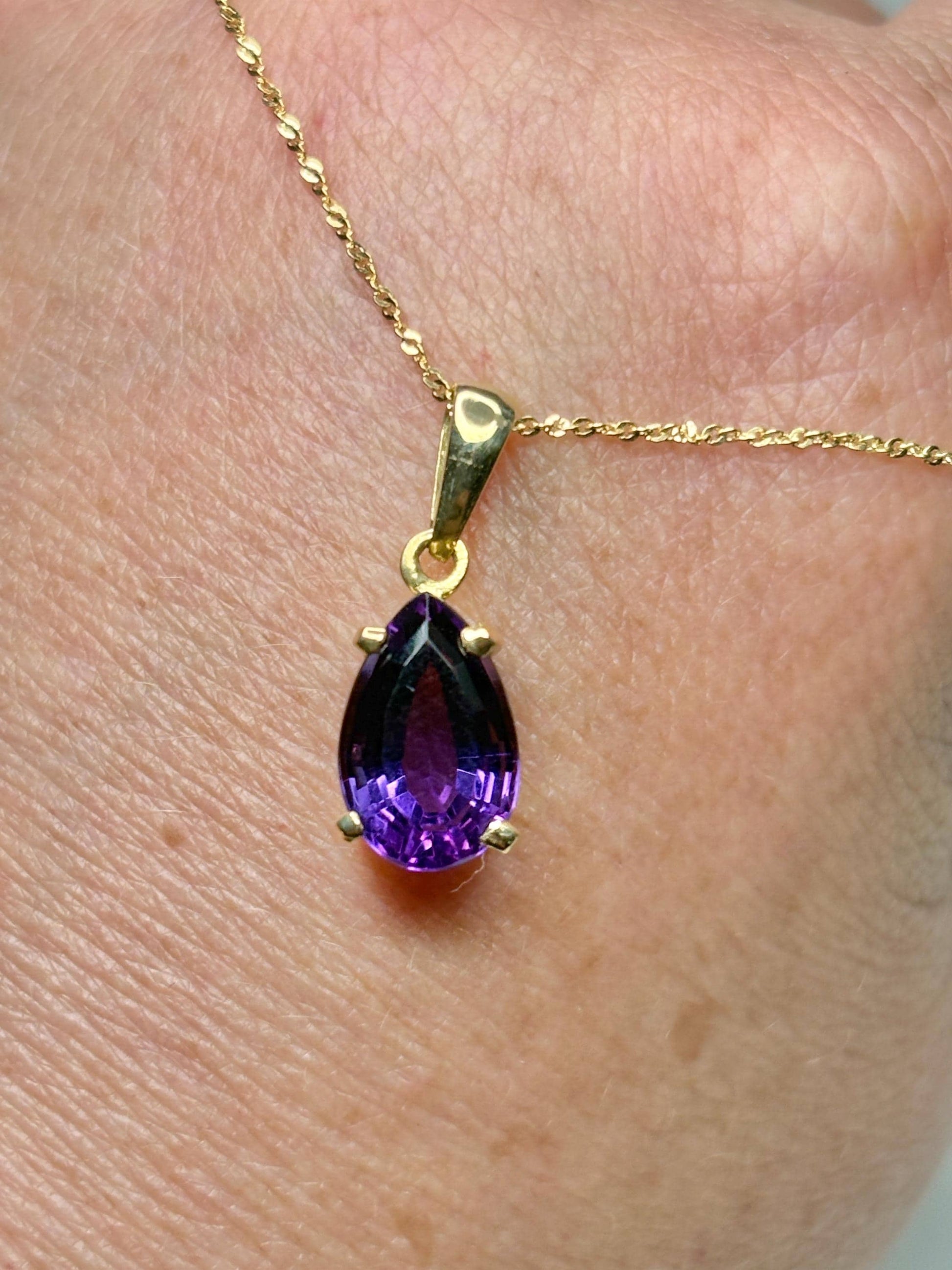 14k gold necklace with a pear-shaped amethyst pendant.