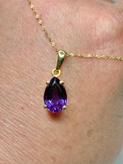 14k gold necklace with a pear-shaped amethyst pendant.