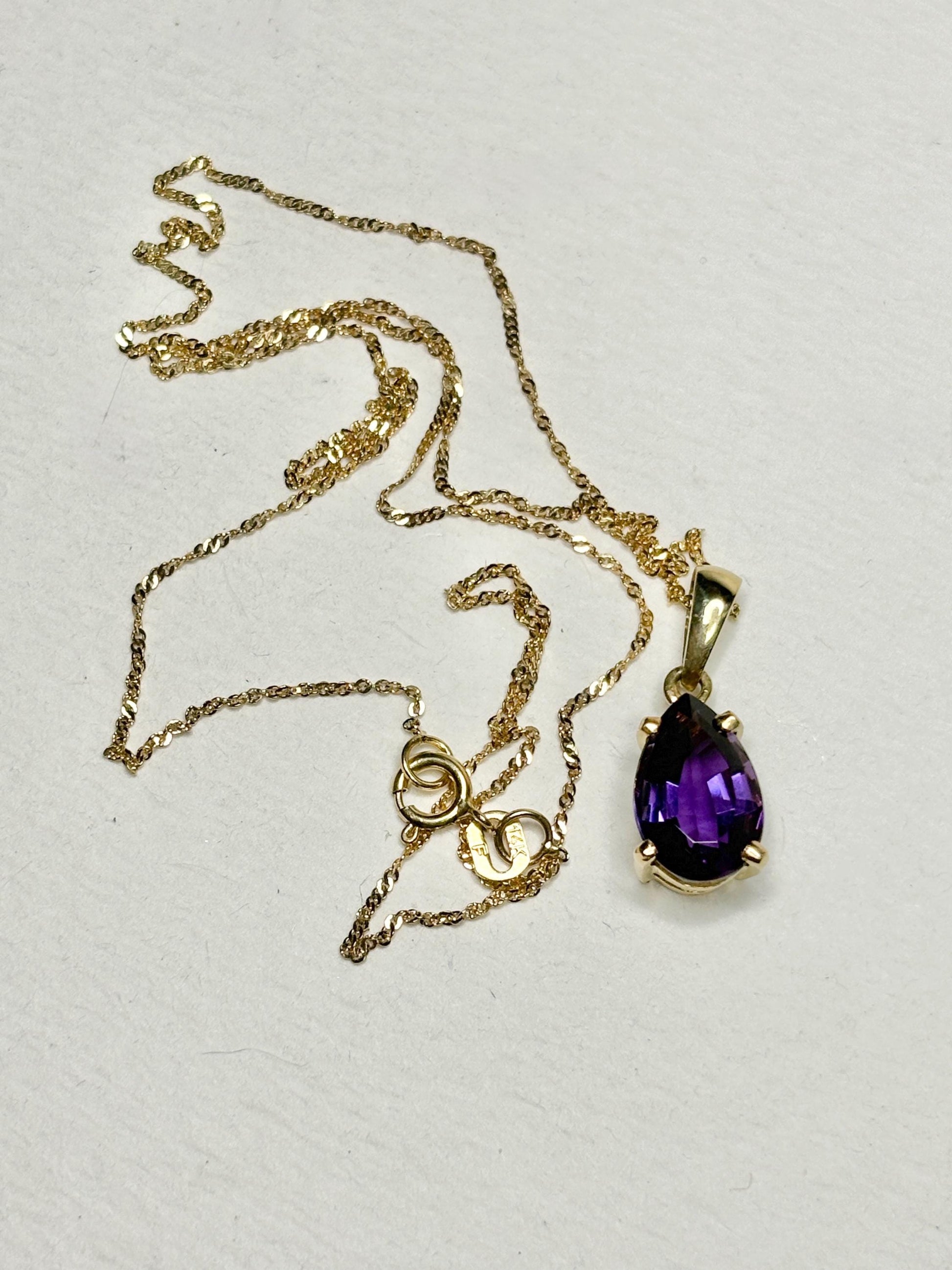 Amethyst pear drop pendant necklace on a 14k gold rope chain.
