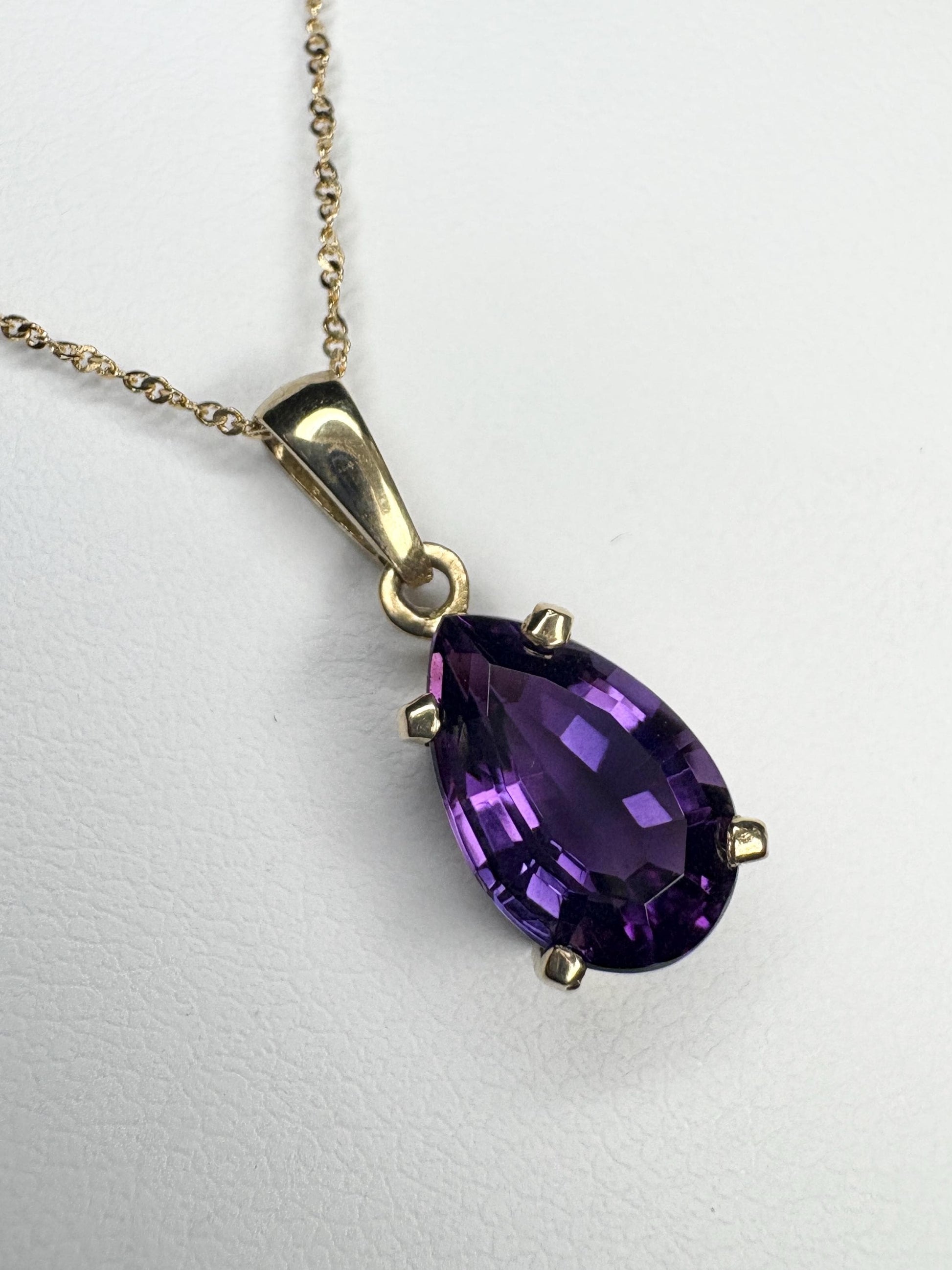 14k gold necklace with a pear-shaped amethyst pendant.