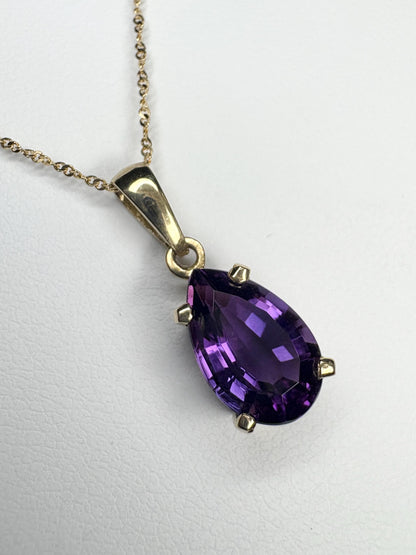 14k gold necklace with a pear-shaped amethyst pendant.