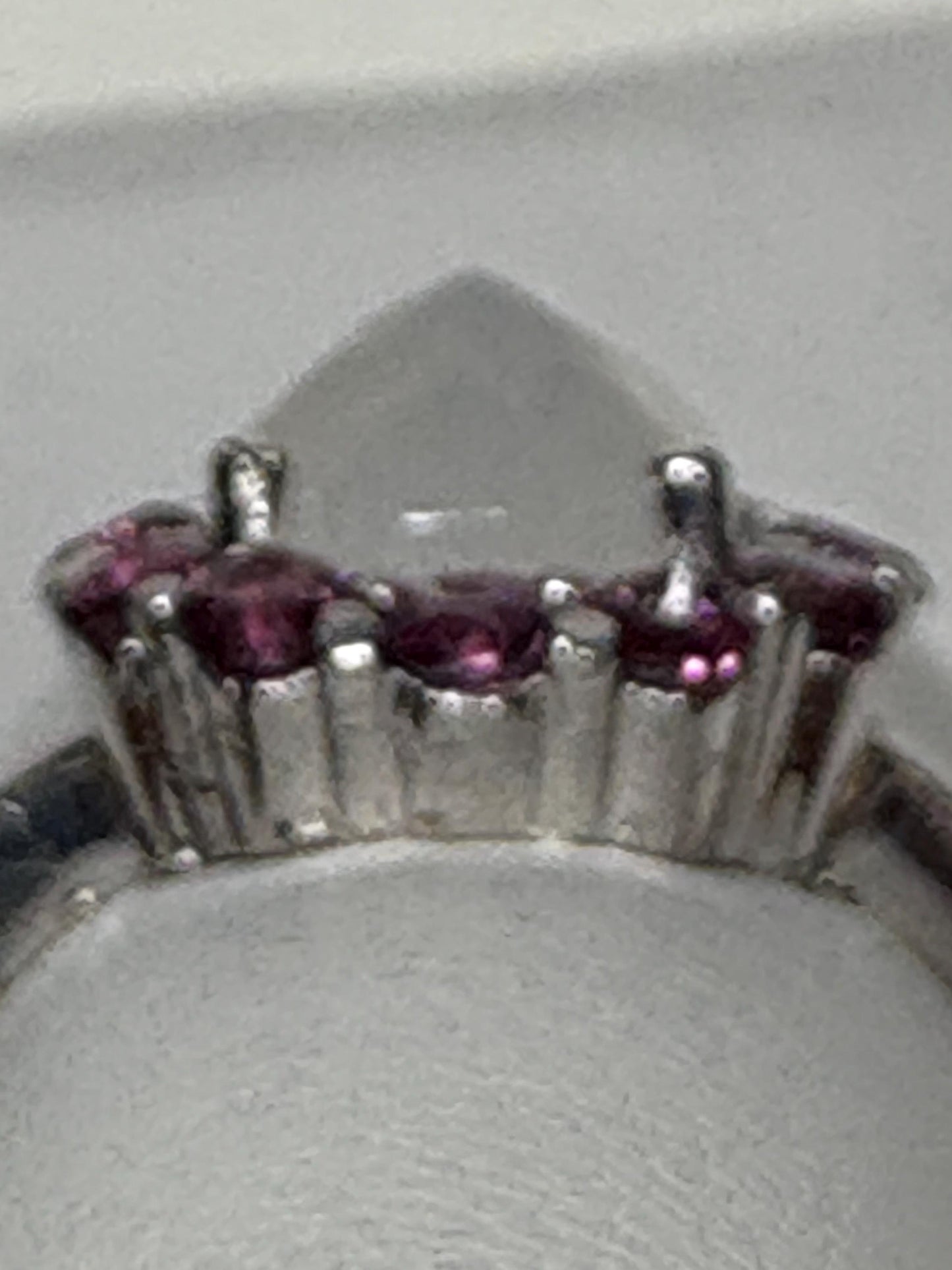 Sterling silver ring with a pear-shaped rainbow moonstone and round rhodolite garnets.