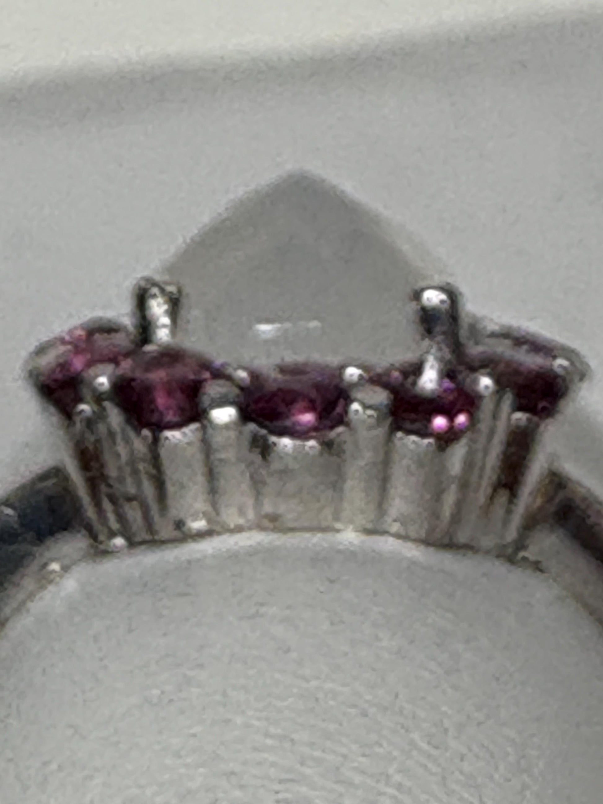 Sterling silver ring with a pear-shaped rainbow moonstone and round rhodolite garnets.