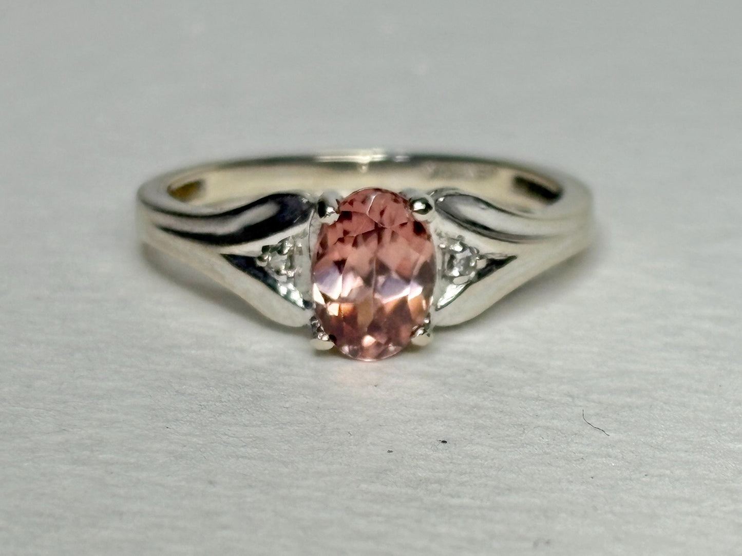 10k white gold ring with a blush pink zircon and diamond accents.