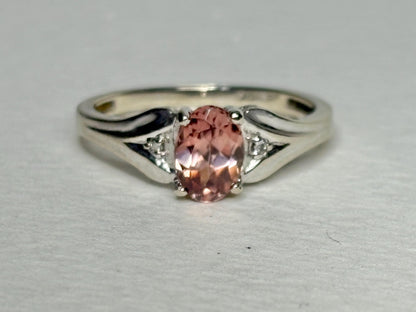 10k white gold ring with a blush pink zircon and diamond accents.