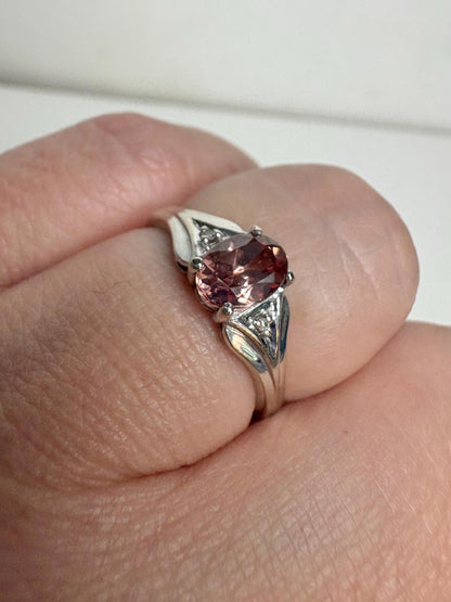 Oval blush pink zircon ring with diamond accents in 10k white gold.