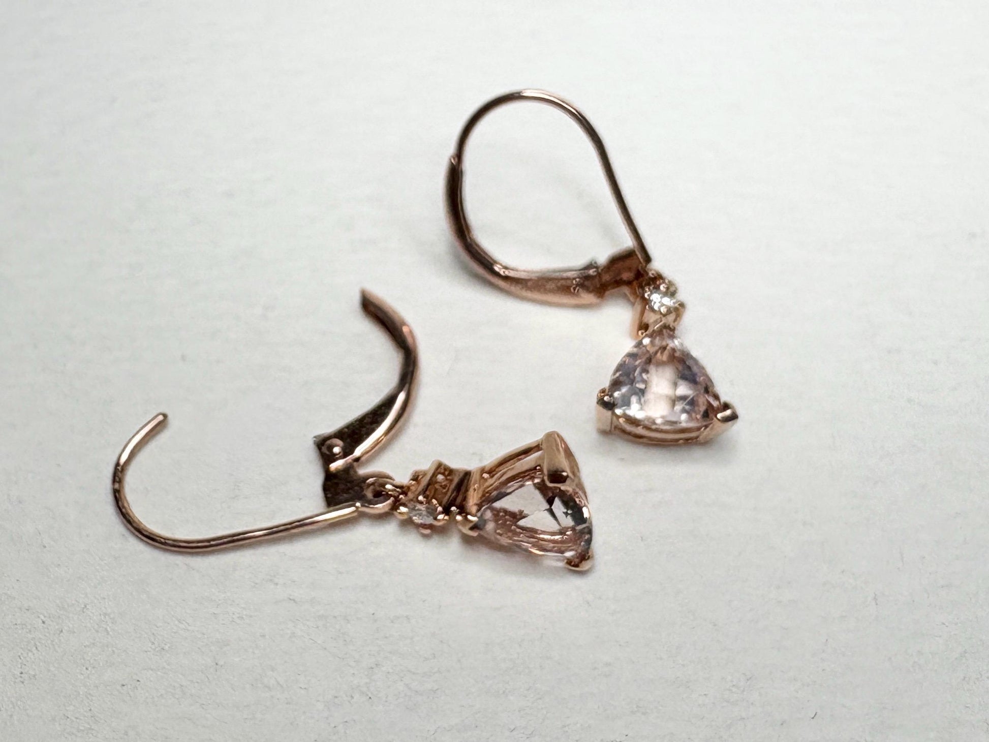 Rose gold dangle earrings with trillion morganite and diamond accents.