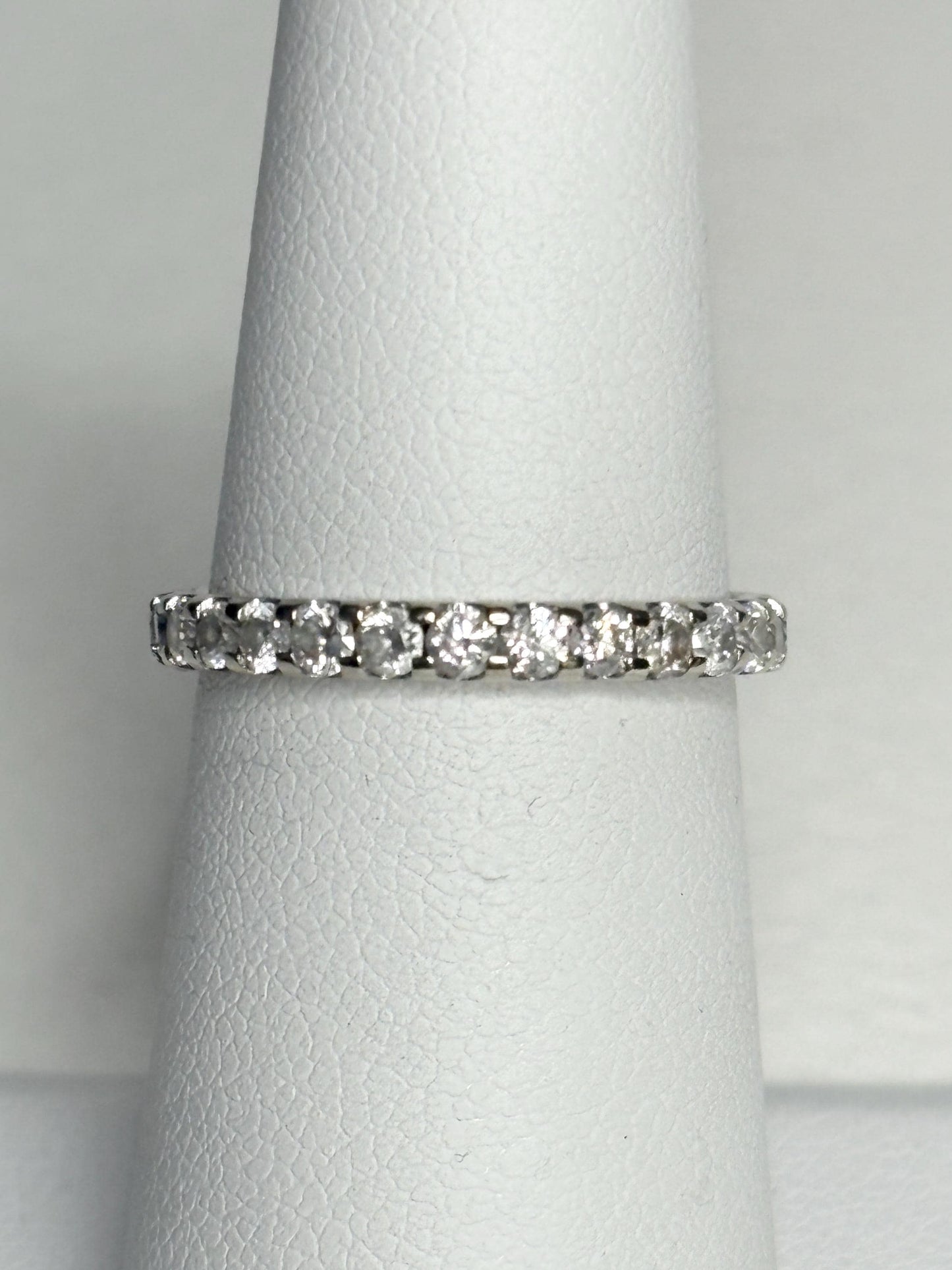 A 14k white gold full eternity band ring with 1ctw of diamonds.