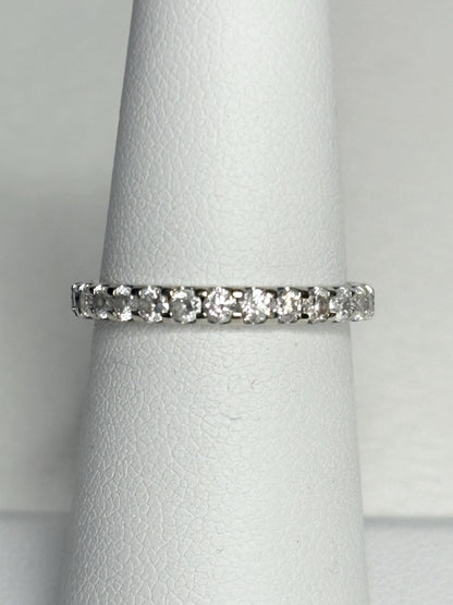 A 14k white gold full eternity band ring with 1ctw of diamonds.