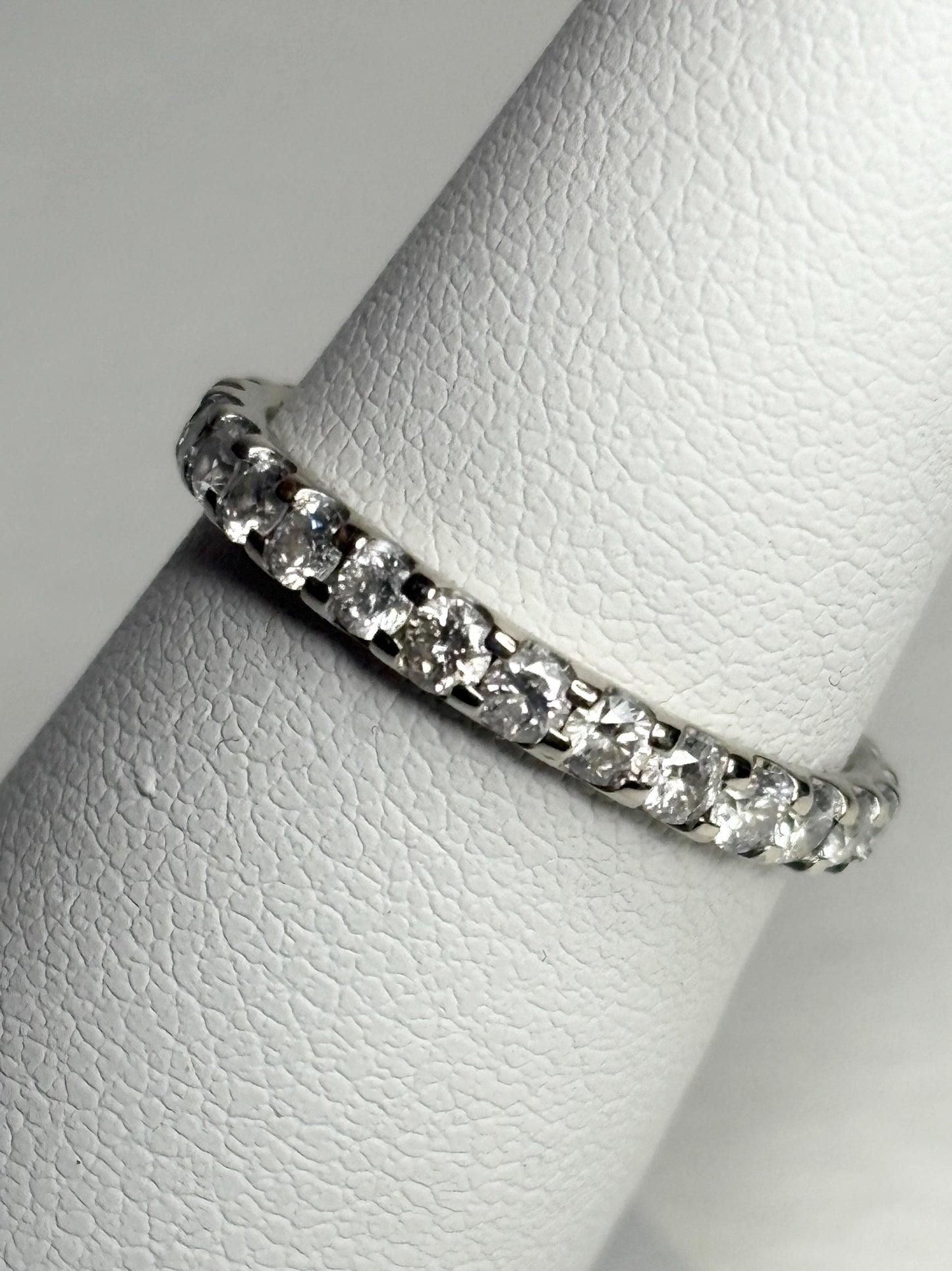 A 14k white gold full eternity band ring with 1ctw of diamonds.
