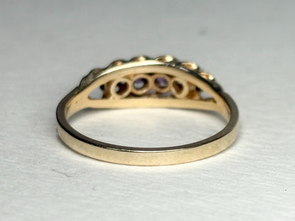 A 10k gold band ring with four rhodolite garnets.