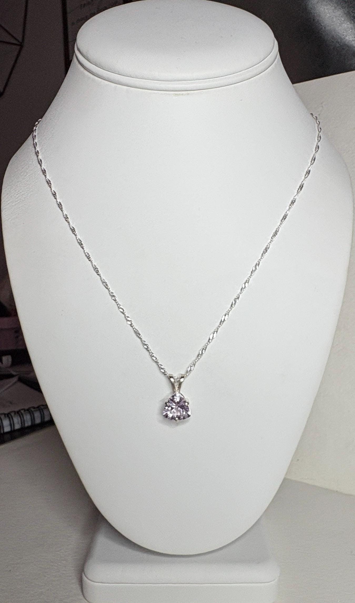 Sterling silver necklace with a trillion-cut kunzite pendant.