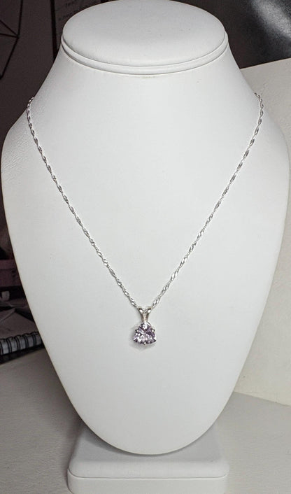 Sterling silver necklace with a trillion-cut kunzite pendant.