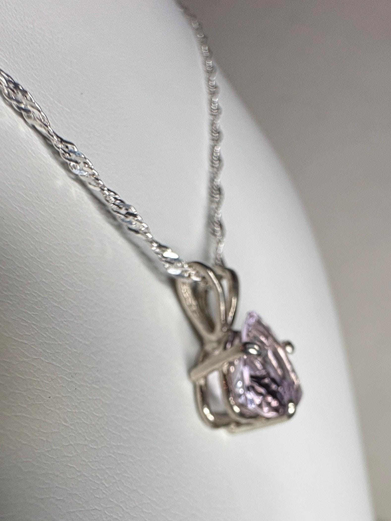 Sterling silver pendant necklace with a trillion cut kunzite gemstone.