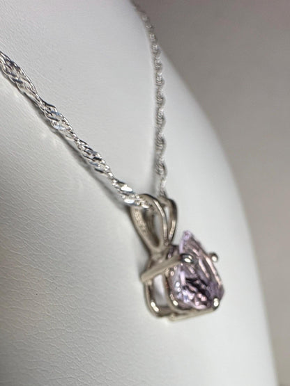 Sterling silver pendant necklace with a trillion cut kunzite gemstone.